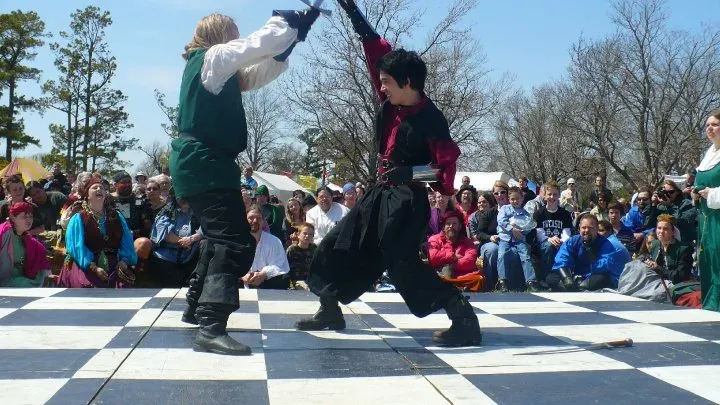 An acrobatic stunt fall performed during a staged fight