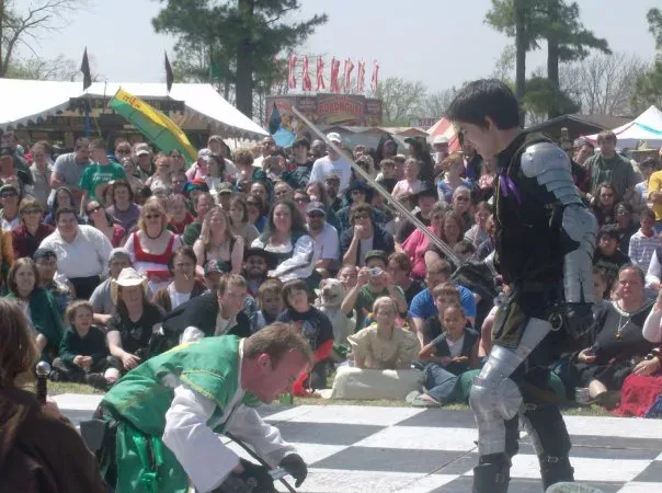 Staged combat performed in front of a seated audience