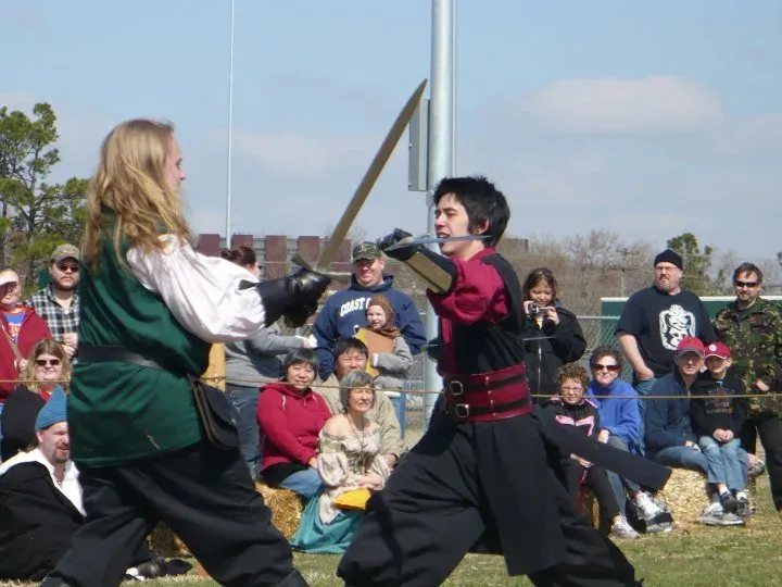A staged fight performed on grass in front of an outdoor audience