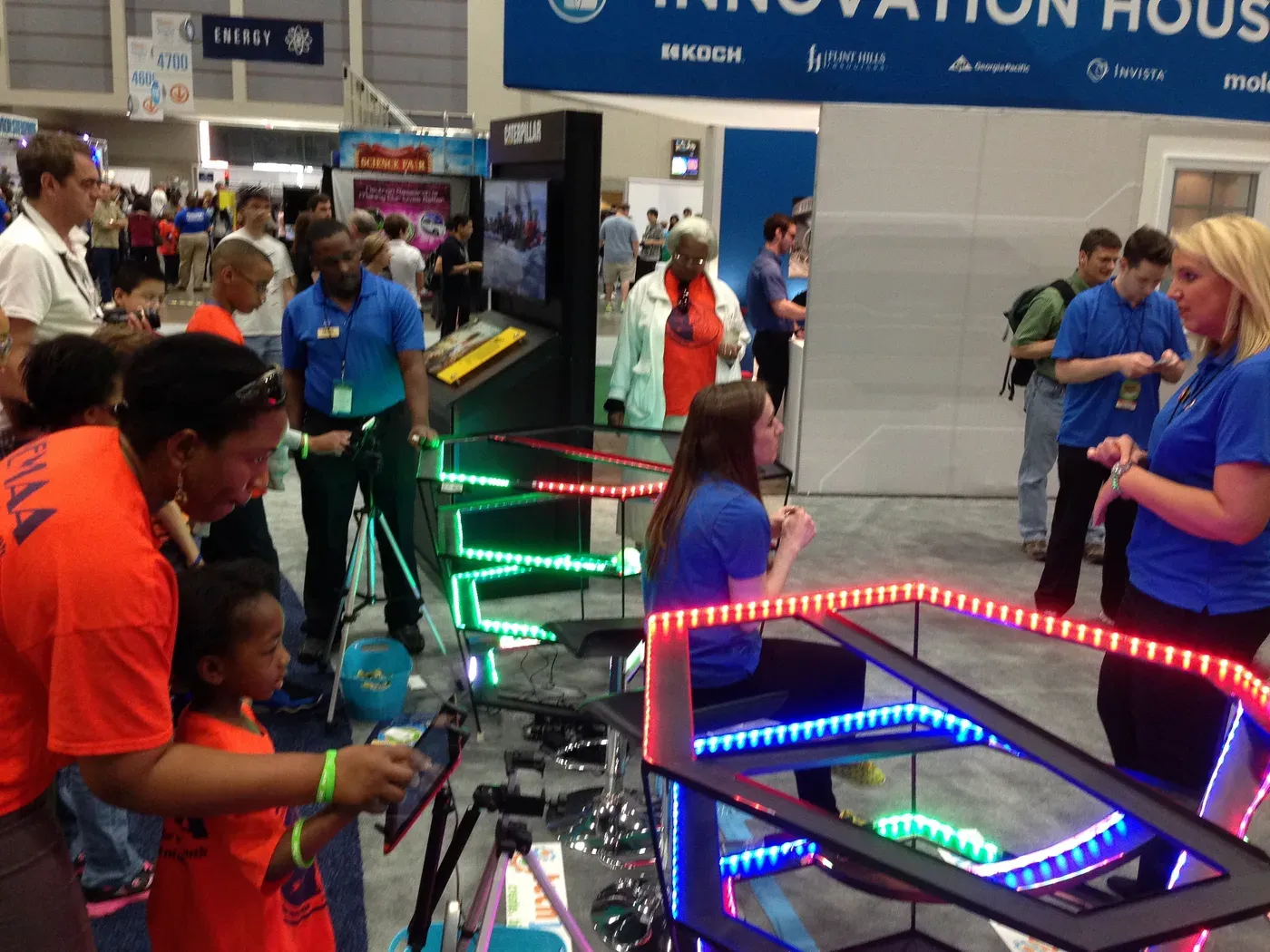 Students trying out robotics equipment at a STEM outreach event